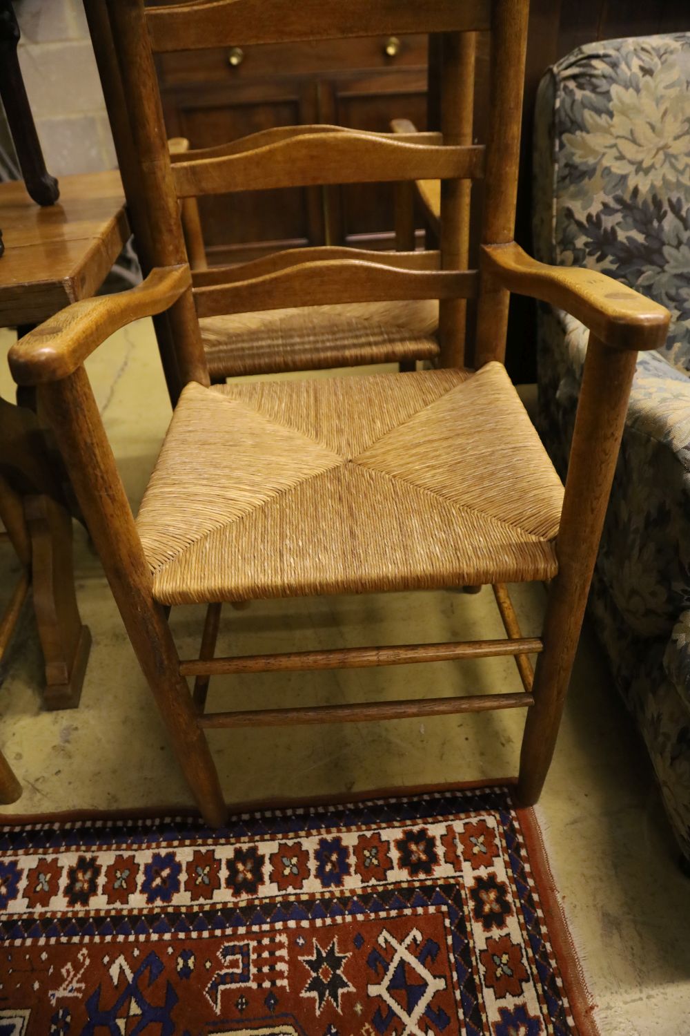 A set of eight ladder back rush seat dining chairs